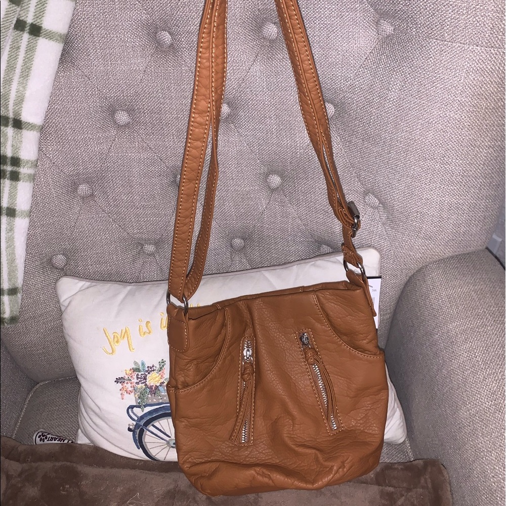 BRAND NEW Bueno crossbody bag. Faux leather with lots of zippers and pockets.